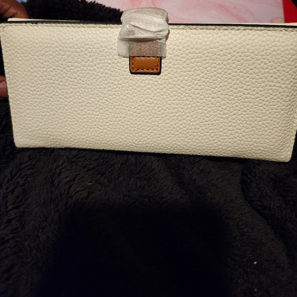 White wallet with brown accents